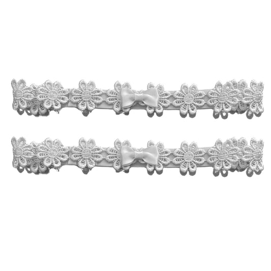 white flower leg garters with satin bow on white background