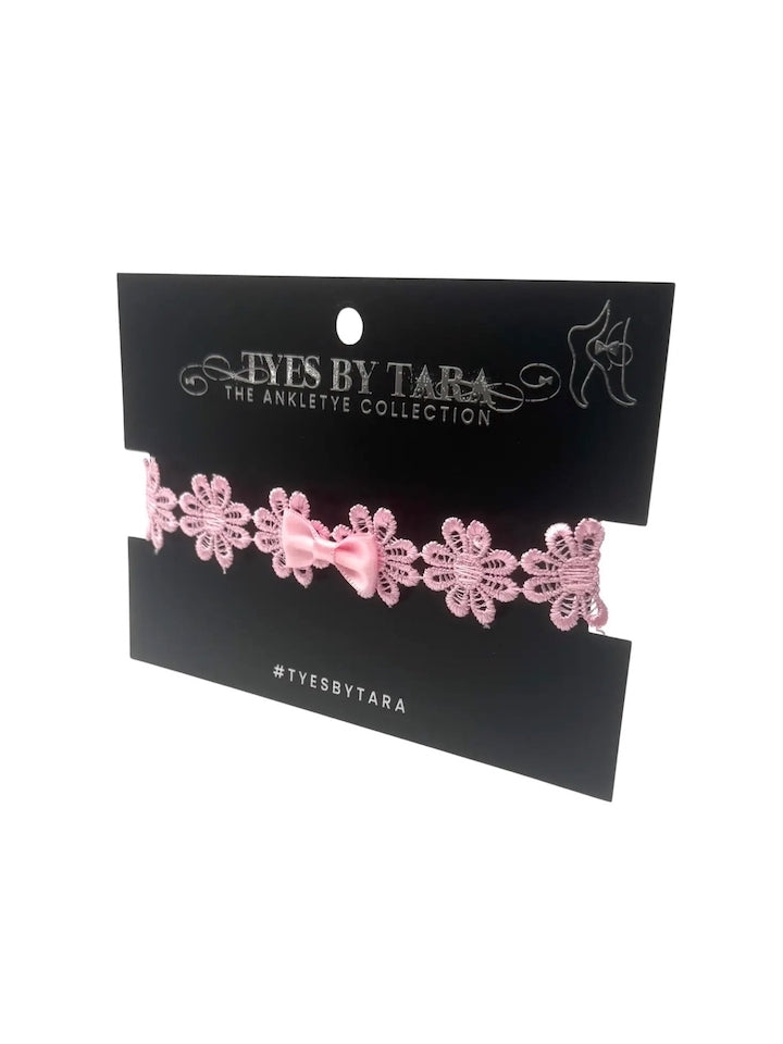 pink bow anklet on black card