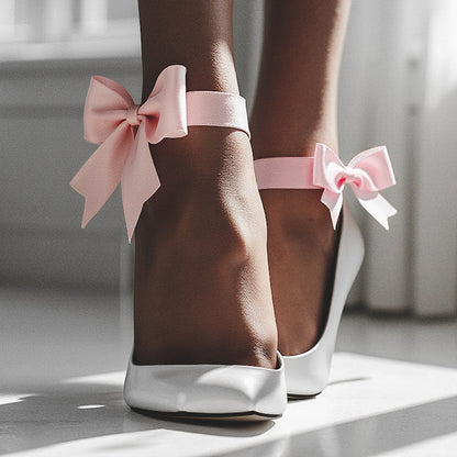 bombshell pink bow heel straps on model with white heels