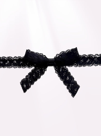 Bougee Bold Black Lace Bow Belt on Light Pink Background Close Up View