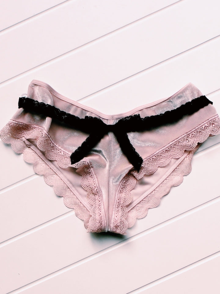 Bougee Bold Black Lace Bow Belt on Light Pink Background on Pink Underwear