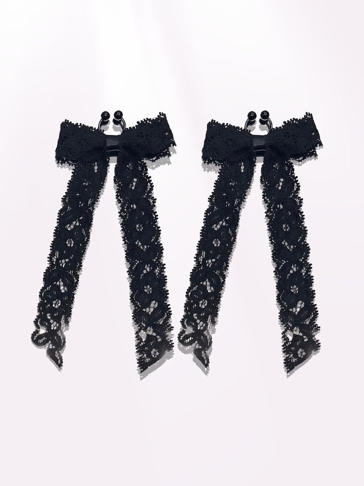 Bougee Black Lace Bow Nipple Clamps on Pink Background