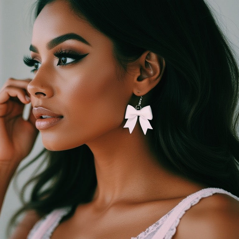 White Bow Bombshell Earrings on Dark Model with Pretty Makeup