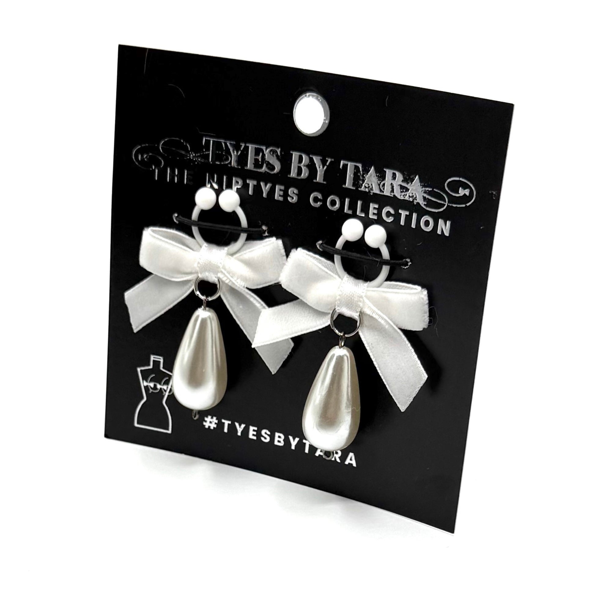 pearl nipple clamps velvet bows with pearl teardrops on black card with white background