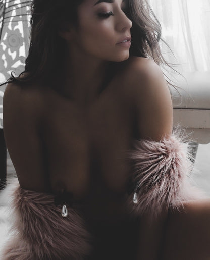marie antoinette pearl nipple clamps on model in white boudoir with pink faux fur coat