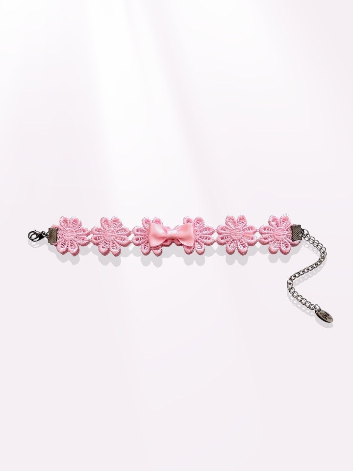 pink flower bow bracelet on light pink background