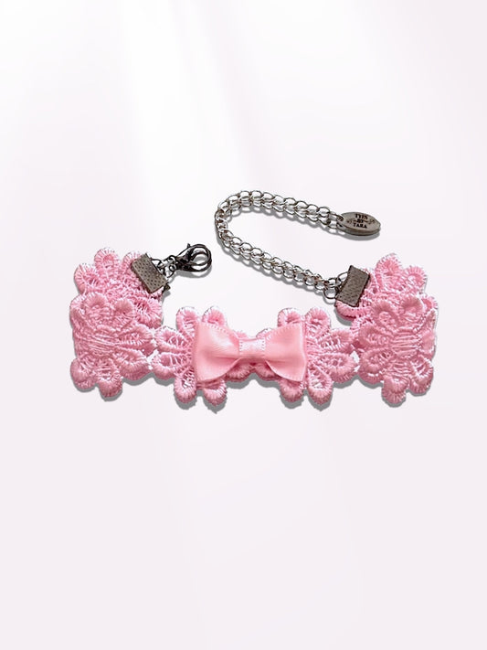 pink flower bow bracelet on light pink background
