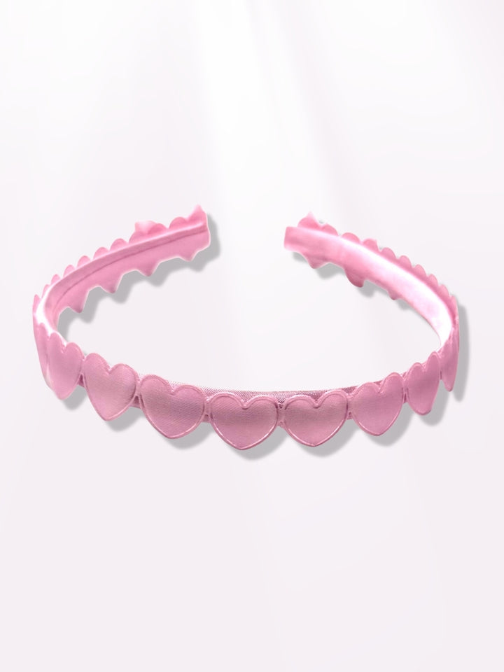 pink heart headband on light pink background