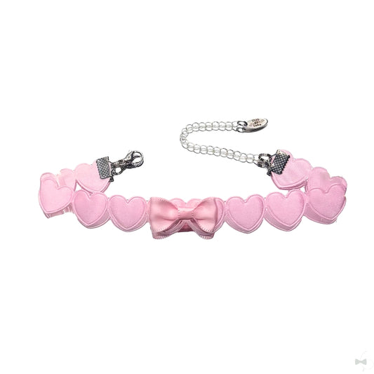 pink heart bow anklet on white background