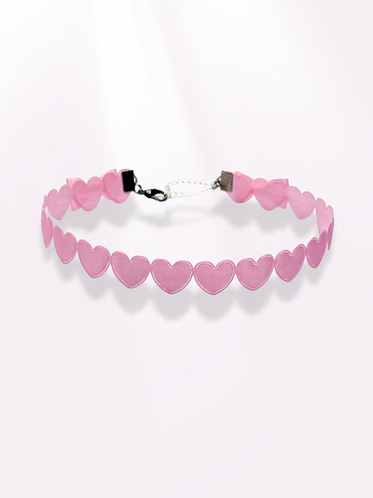 pink heart bow choker on light pink background