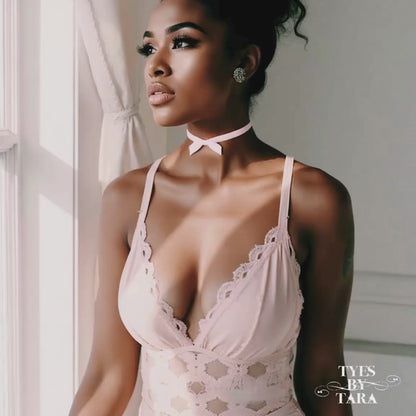 Dark toned model in pink lingerie in marie antoinette pink velvet choker