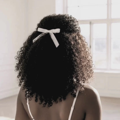 White Velvet Hair Bow on Dark Skinned Model with Curly Hair
