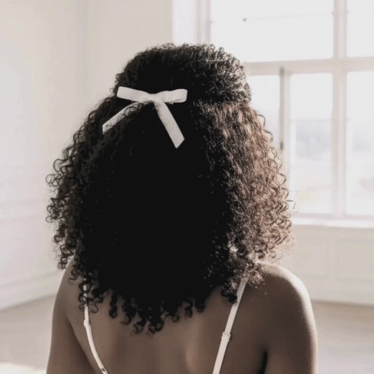 White Velvet Hair Bow on Dark Skinned Model with Curly Hair