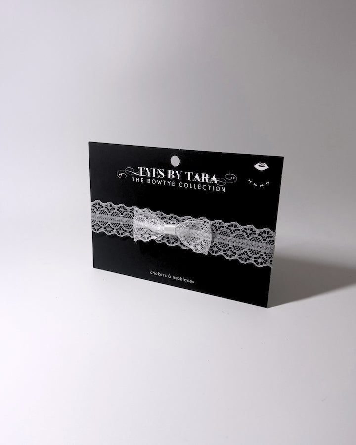 Siren White Lace Bow Choker on light gray background on black card