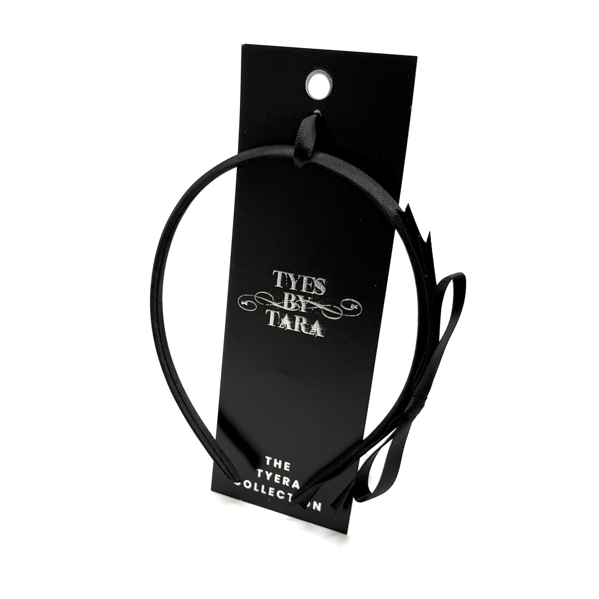 Black headband on a 'Tyes by Tara' branded card against a white background