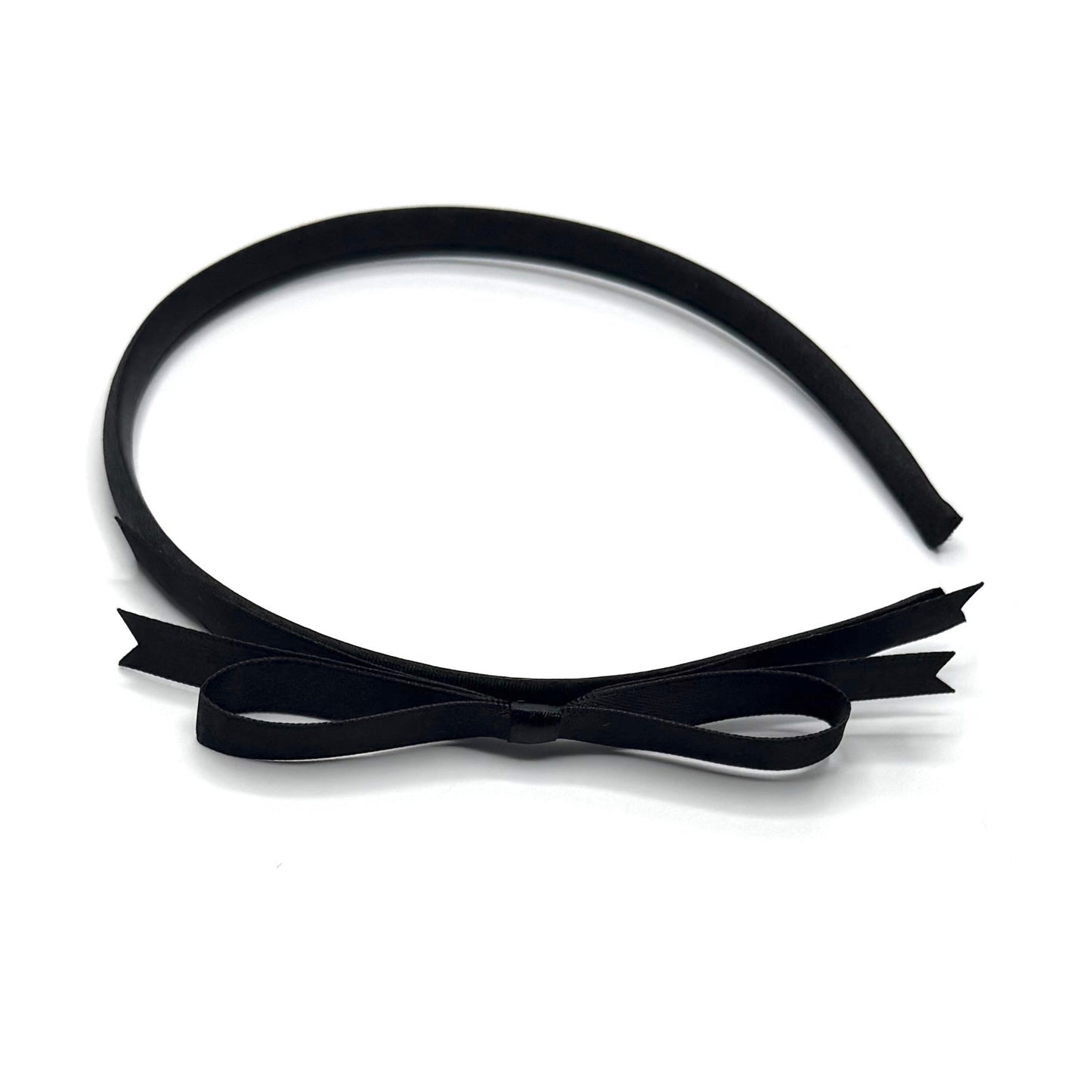 Black headband with a bow on a white background