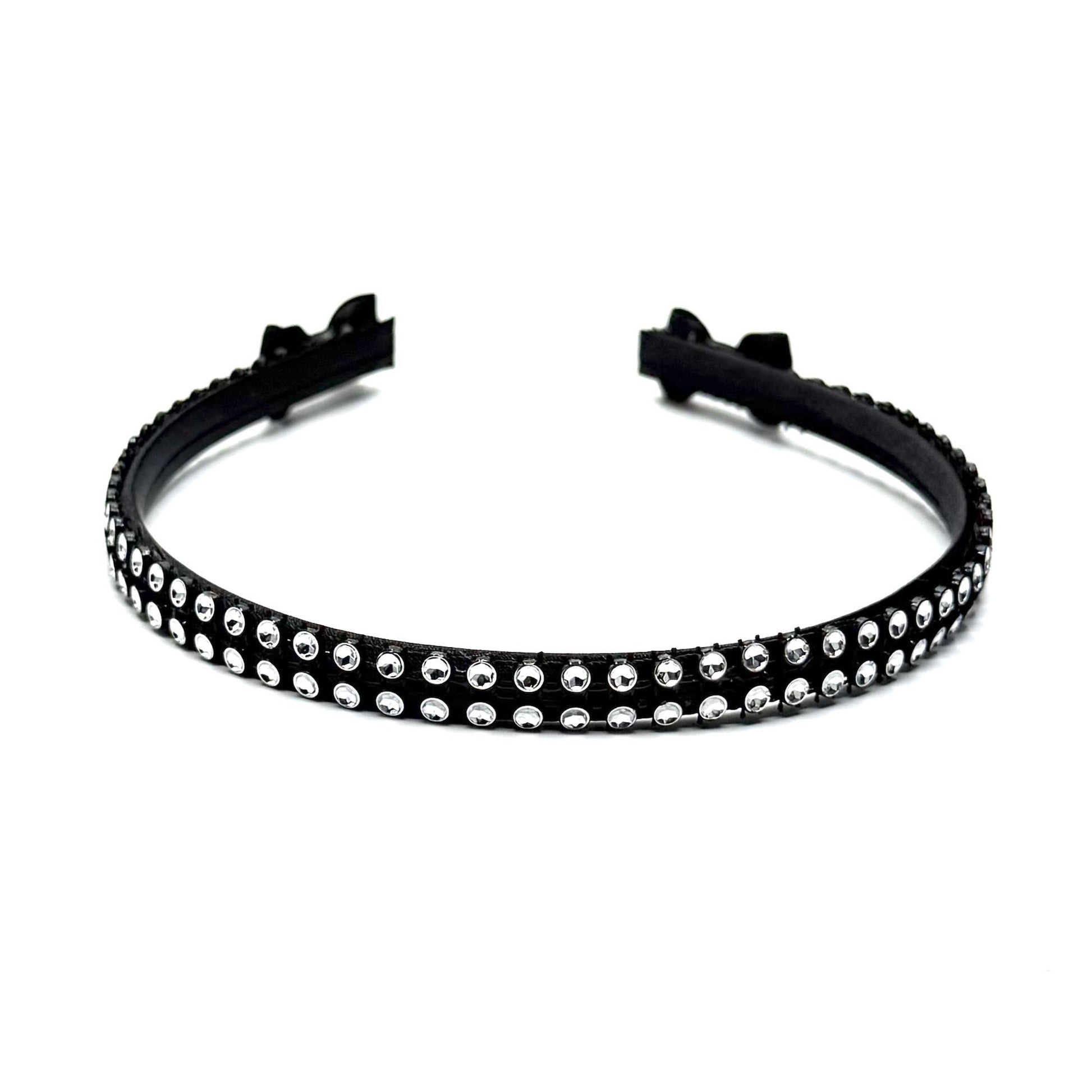 Black hairband with black and silver rhinestone mesh with black bows at the end on white background Top View