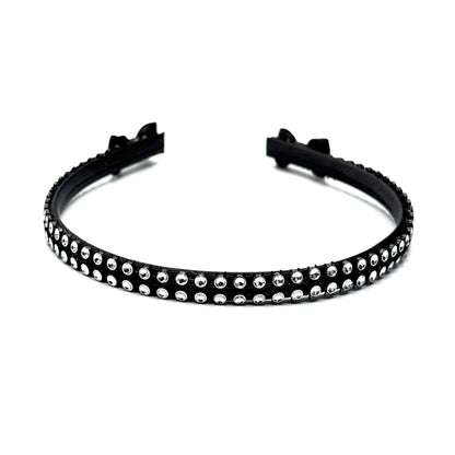 Black hairband with black and silver rhinestone mesh with black bows at the end on white background Top View
