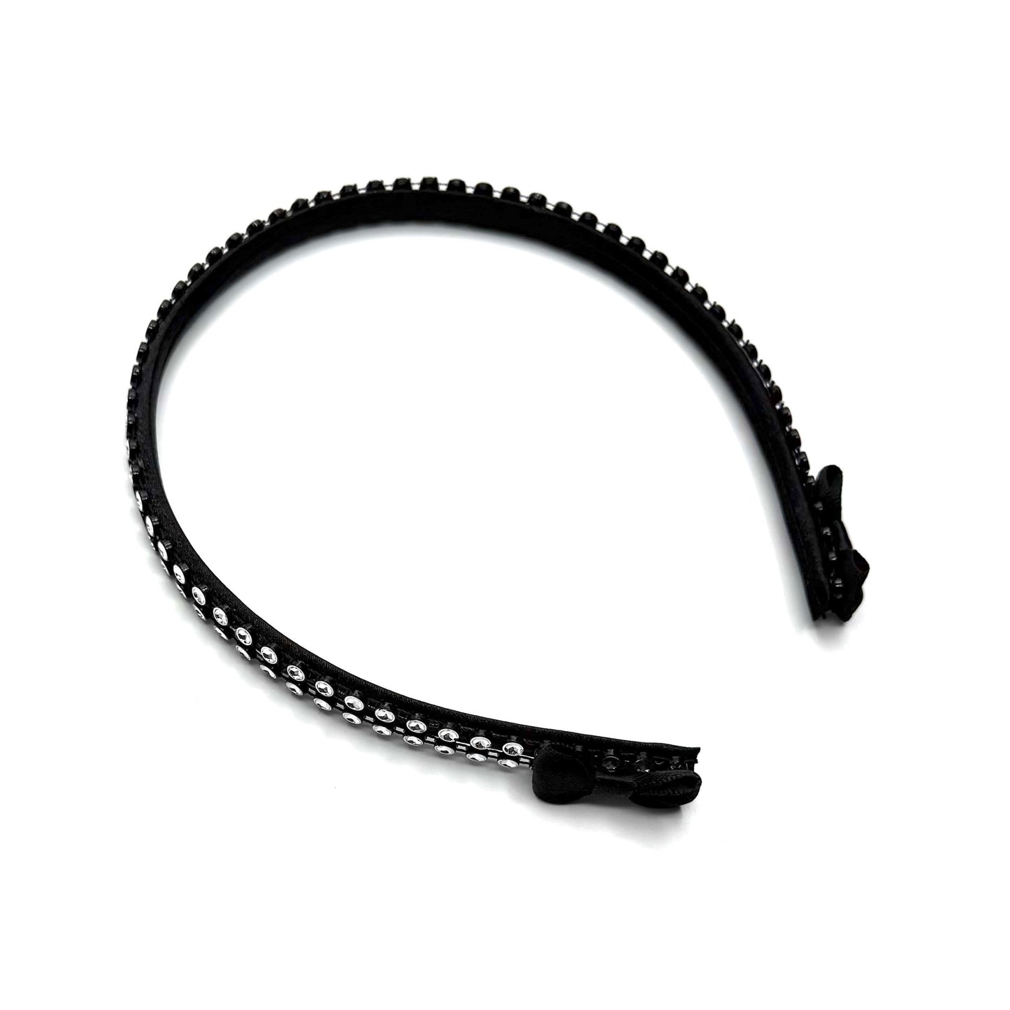 Black hairband with black and silver rhinestone mesh with black bows at the end on white background