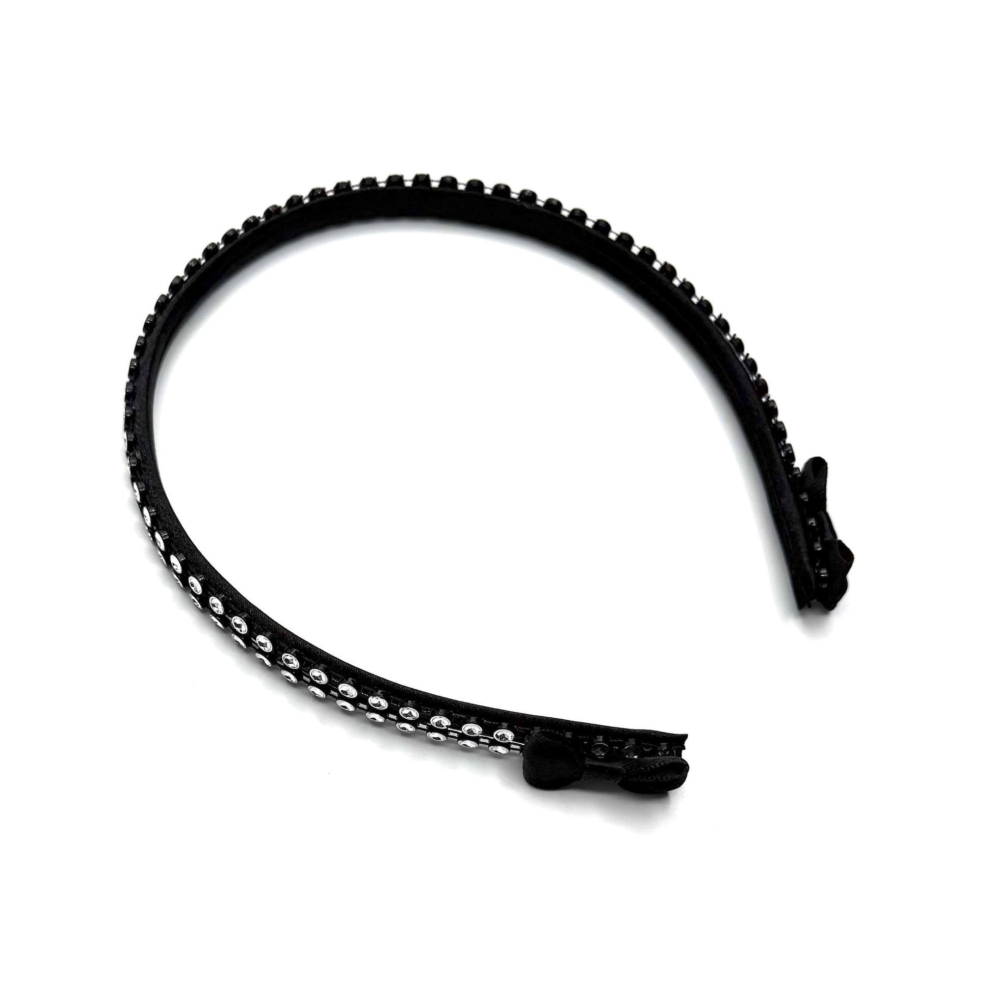 Black hairband with black and silver rhinestone mesh with black bows at the end on white background
