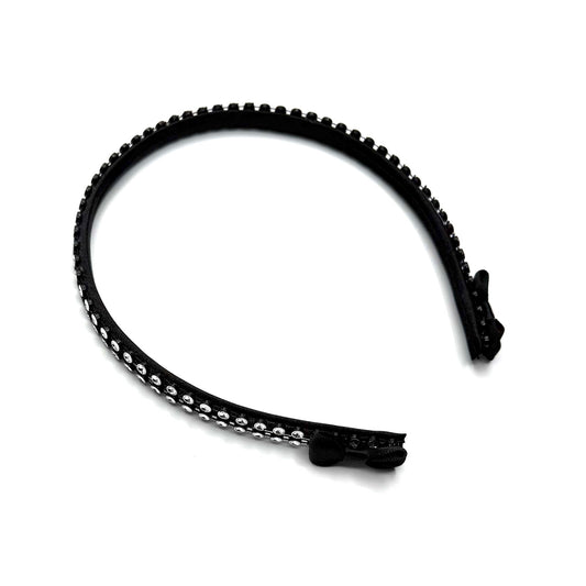 Black hairband with black and silver rhinestone mesh with black bows at the end on white background