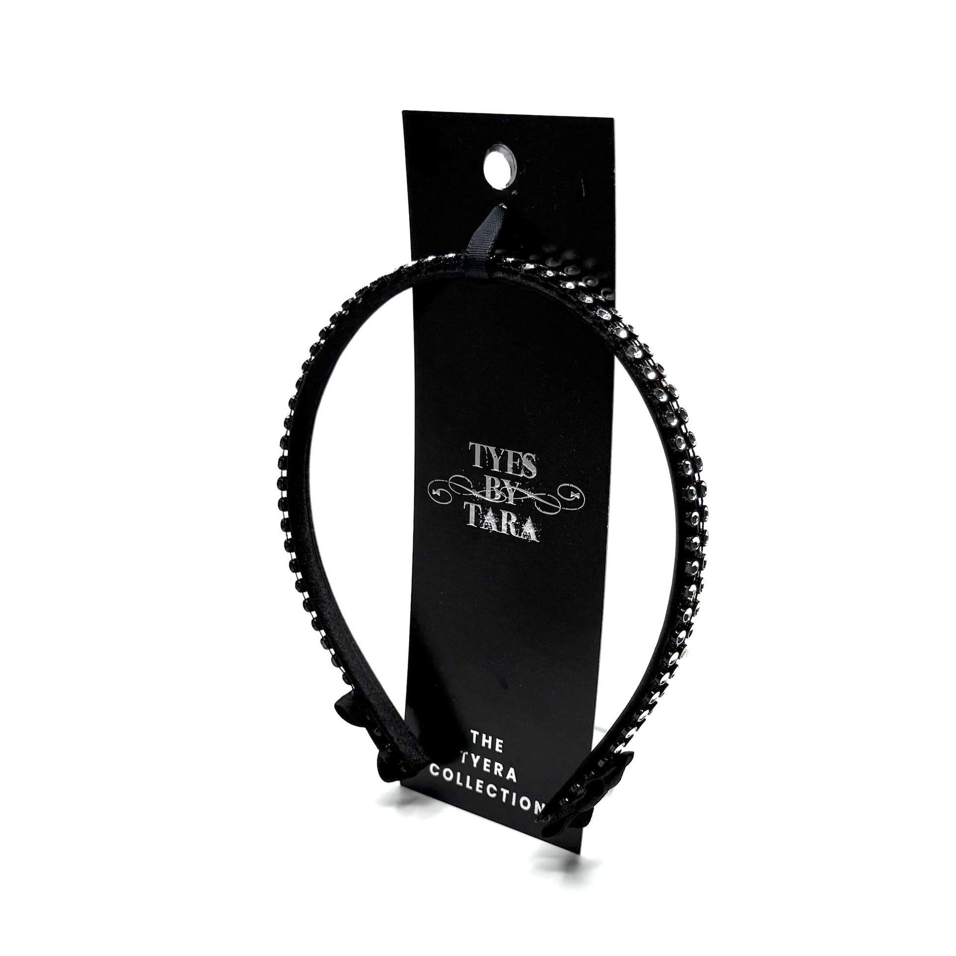 Black hairband with black and silver rhinestone mesh with black bows at the end on white background Packaging View